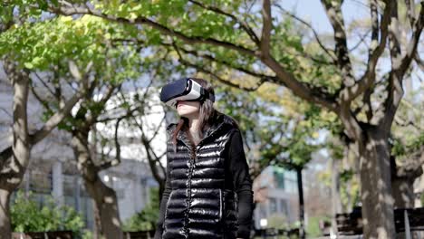 Focused-woman-in-VR-headset-in-park